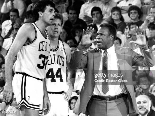 Boston Celtics head coach K.C. Jones gestures as he talks with players Kevin McHale, left, and Danny Ainge during Game Five of the third round of the...