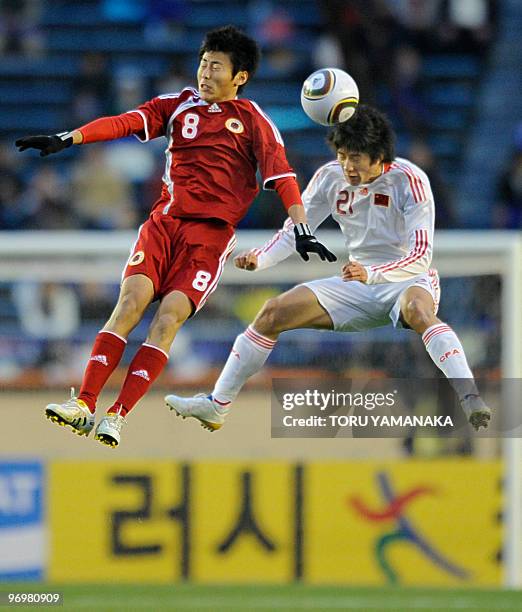 Chinese midfielder Yu Hai battles for the ball with Hong Kong midfielder Xu Deshuai in the air during their match of the East Asian football...