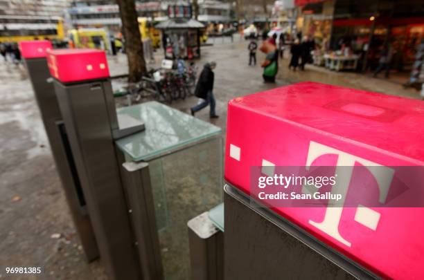 People walk by payphones of German telecommunications provider Deutsche Telekom on February 23, 2010 in Berlin, Germany. Deutsche Telekom is to...