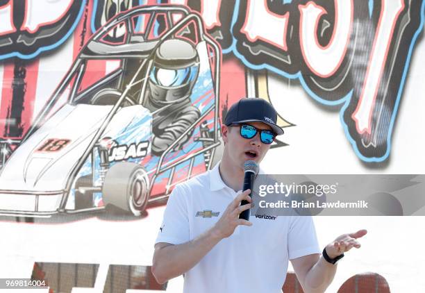 Josef Newgarden, driver of the Verizon Team Penske Chevrolet, visits with the USAC Quarter Midget racing participants during practice for the Verizon...