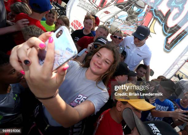 Josef Newgarden, driver of the Verizon Team Penske Chevrolet, visits with the USAC Quarter Midget racing participants during practice for the Verizon...