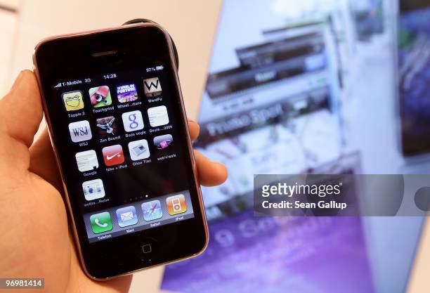 The photographer holds an iPhone at a shop of German telecommunications provider Deutsche Telekom on February 23, 2010 in Berlin, Germany. Deutsche...