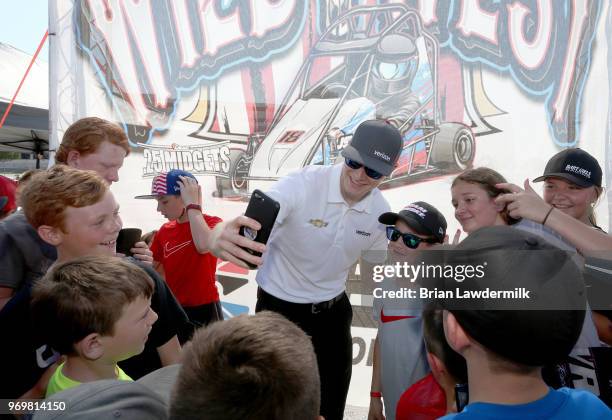 Josef Newgarden, driver of the Verizon Team Penske Chevrolet, visits with the USAC Quarter Midget racing participants during practice for the Verizon...