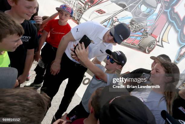 Josef Newgarden, driver of the Verizon Team Penske Chevrolet, visits with the USAC Quarter Midget racing participants during practice for the Verizon...