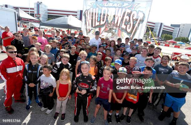 Josef Newgarden, driver of the Verizon Team Penske Chevrolet, visits with the USAC Quarter Midget racing participants during practice for the Verizon...