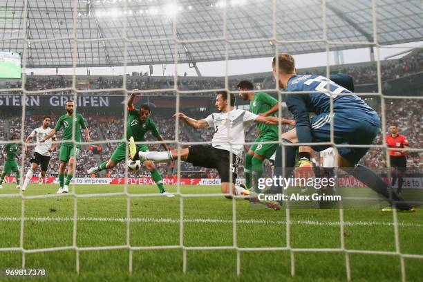 Taisir Al-Jassim of Saudi Arabia scores his team's first goal past Mats Hummels and goalkeeper Marc-Andre ter Stegen of Germany during the...