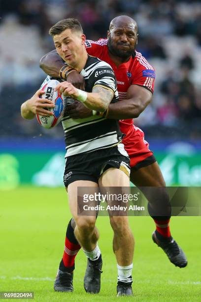 Jamie Shaul of Hull FC is tackled by Robert Lui of Salford Red Devils during the Betfred Super League match between Hull FC and Salford Red Devils at...
