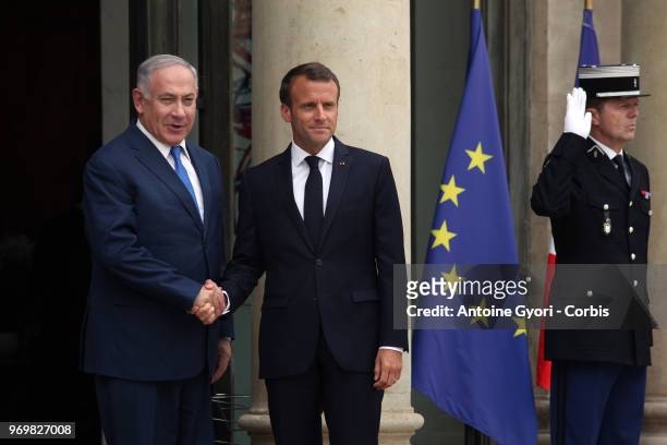 French President Emmanuel Macron welcomes Israeli Prime Minister Benjamin Netanyahu prior to their meeting at the Elysee Presidential Palace on June...