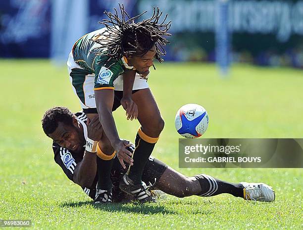 Cecil Africa of South Africa is tackled by Tomasi Cama of New Zeland during the 2010 USA Rugby Sevens tournament at the Sam Boyd Stadium in Las...
