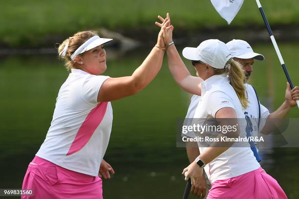 Alice Hewson and India Clyburn celebrate on the fifth green during foursomes matches on day one of the 2018 Curtis Cup at Quaker Ridge Golf Club on...