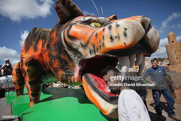 Workers pass an oversized tiger as they put the final touches on dozens of colourful floats to be used next week in Purim carnivals throughout the...
