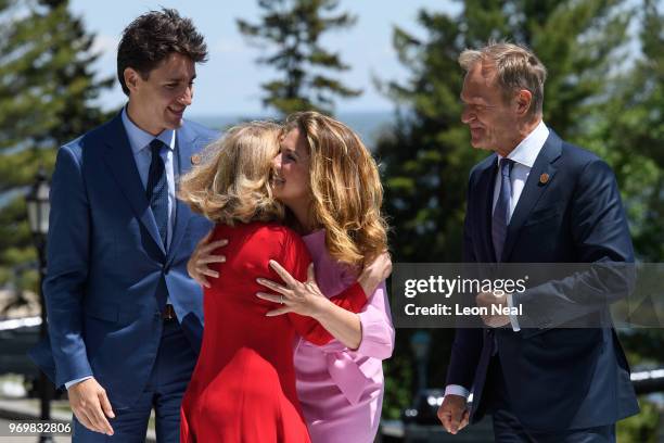 Canada's Prime Minister Justin Trudeau and President of the European Council Donald Tusk look on as their wives Malgorzata Tusk and Sophie Gregoire...