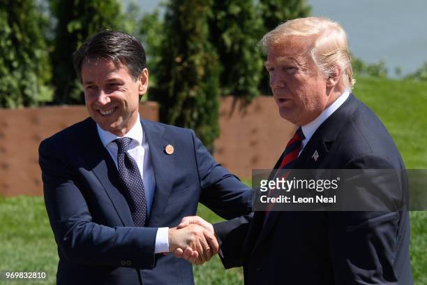 Italy's Prime Minister Giuseppe Conte shakes hands with the President of the United States Donald Trump on the first day of the G7 Summit, on 8 June,...