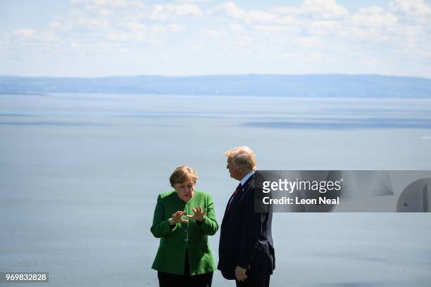 Germany's Chancellor Angela Merkel and President of the United States of America Donald Trump speak together following the Family photo on the first...