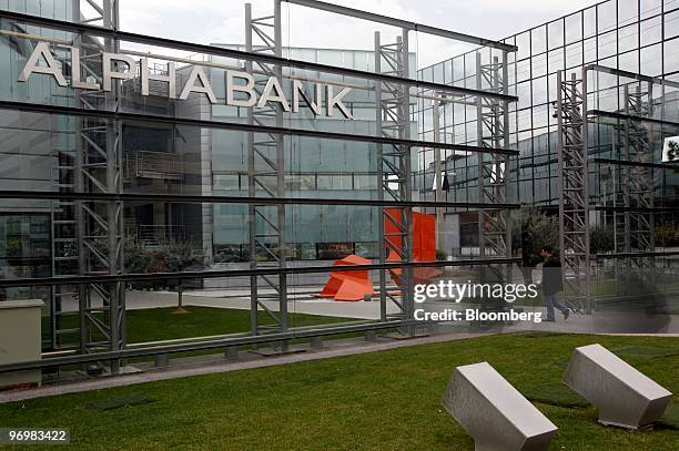 Pedestrian enters a branch of Alpha Bank in Athens, Greece, on Tuesday, Feb. 23, 2010. Greece is not talking to banks about arranging the sale of a...