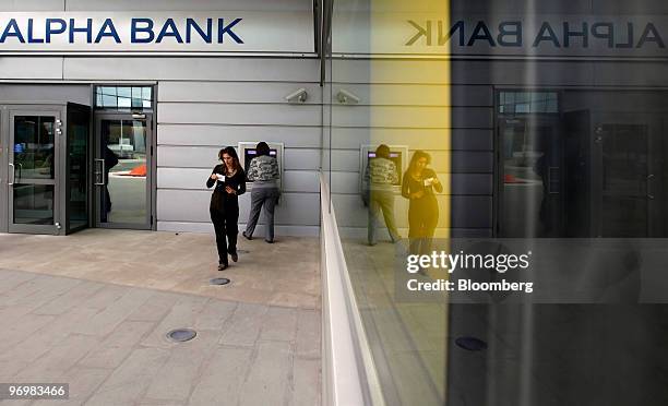 Customers use a branch of Alpha Bank in Athens, Greece, on Tuesday, Feb. 23, 2010. Greece is not talking to banks about arranging the sale of a...