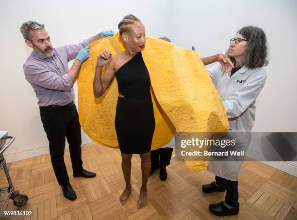 With the help of independent curator Matthew Bird and textile conservator Anne Marie Guchardi , Canadian model Stacey McKenzie puts on a cape made by...