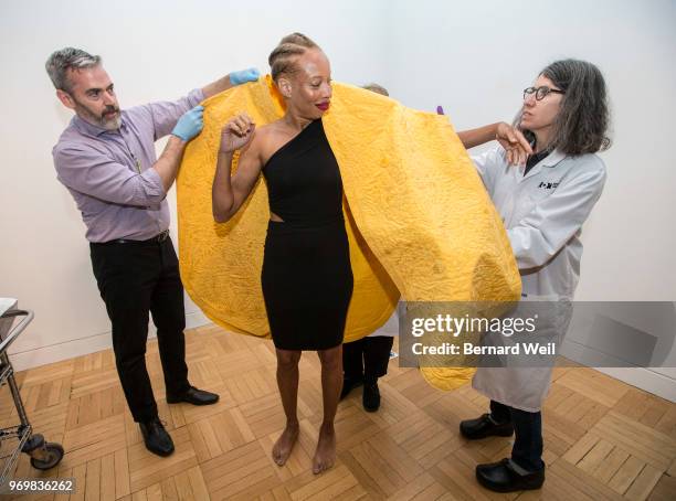 With the help of independent curator Matthew Bird and textile conservator Anne Marie Guchardi , Canadian model Stacey McKenzie puts on a cape made by...