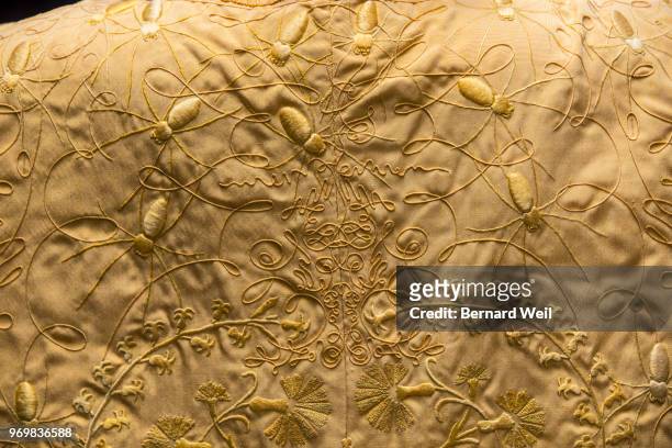 Intricate details form a patters as Canadian model Stacey McKenzie wears a cape, made by the silk of 1.2 million female Golden Orb Weaver spiders,...