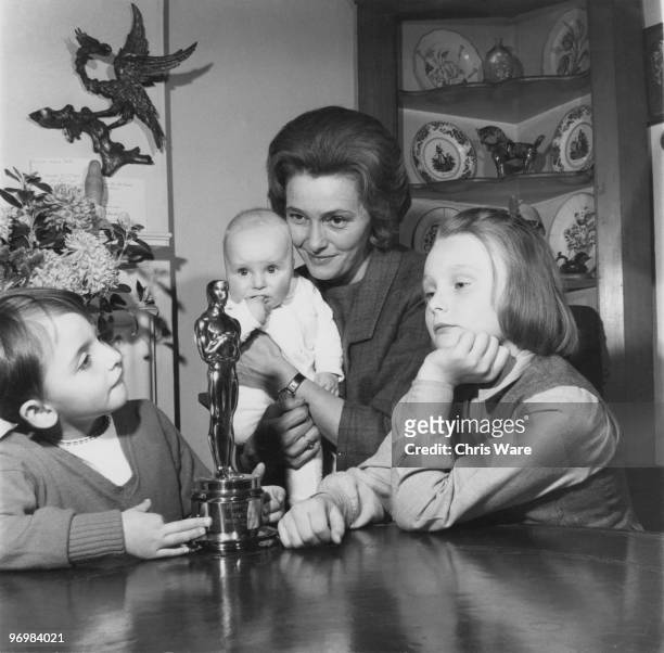 American actress Patricia Neal at home in Great Missenden, Buckinghamshire, with her three children and her Oscar statuette, which she won for her...