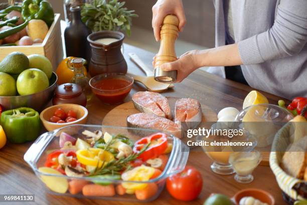 woman cooking in the kitchen ( with fish salmon) - cooking fish stock pictures, royalty-free photos & images