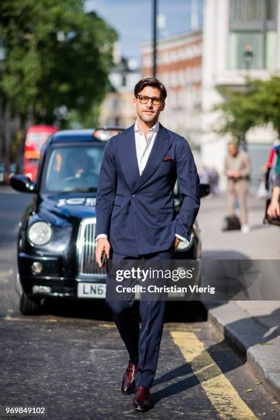 Johannes Huebl waring navy suit is seen outside Iceberg during London Fashion Week Men's June 2018 on June 8, 2018 in London, England.