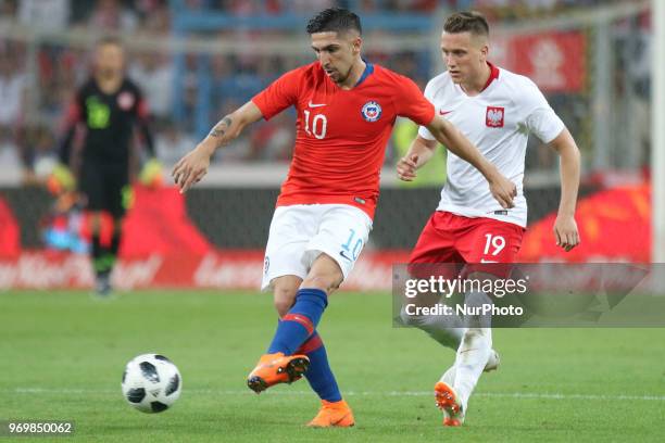 Piotr Zielinski of Poland ompetes with Diego Valdes of Chile during International Friendly match between Poland and Chile on June 8, 2018 in Poznan,...