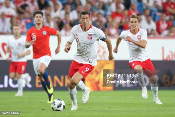 Robert Lewandowski and Arkadiusz Milik of Poland compete with Angelo Sagal of Chile during International Friendly match between Poland and Chile on...