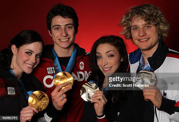 Ice dance figure skaters Tessa Virtue and Scott Moir of Canada, pose with their gold medals alongside silver medal winners Meryl Davis and Charlie...