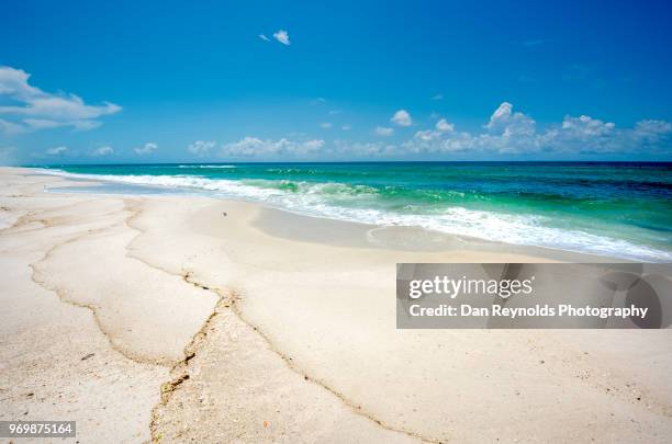 scenic view of sand dunes and sea against sky - pensacola beach stockfoto's en -beelden