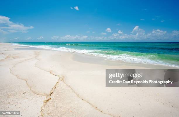 scenic view of sand dunes and sea against sky - pensacola beach stock-fotos und bilder