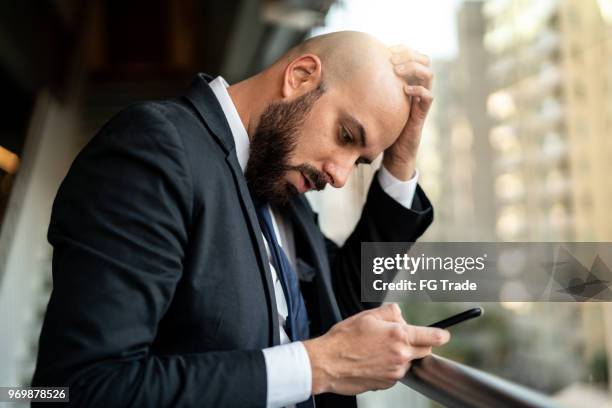 businessman using mobile on coworking - unhappy salesman stock pictures, royalty-free photos & images