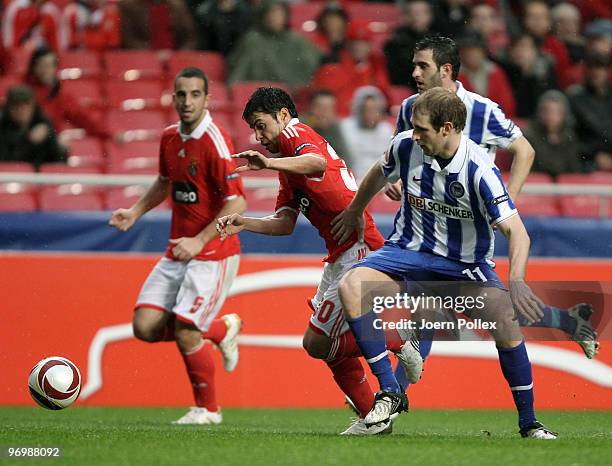 Florian Kringe of Berlin battles for the ball with Ruben Amorim and Javier Saviola of Benfica during the UEFA Europa League knock-out round, second...