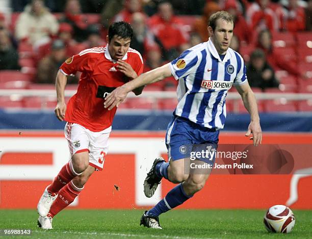 Florian Kringe of Berlin battles for the ball with Javier Saviola of Benfica during the UEFA Europa League knock-out round, second leg match between...