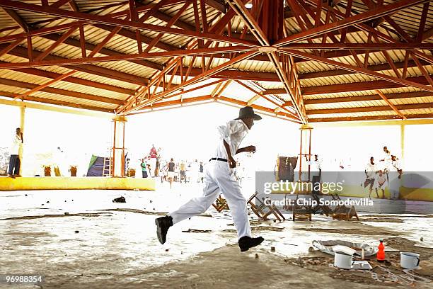 Haitian Voodooists run for cover as their ceremony for earthquake victims came under attack from Christian residents of the Ti Ayiti neighborhood...