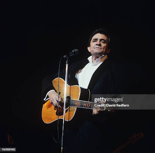 American singer Johnny Cash performs on stage at the Hammersmith Odeon in London, England on November 15, 1983.