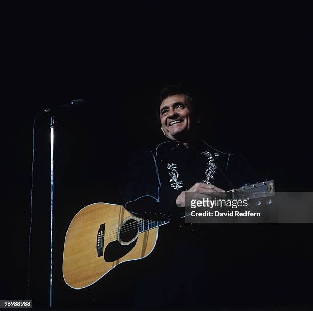 American singer Johnny Cash performs on stage at the Hammersmith Odeon in London, England on November 15, 1983.