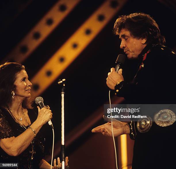 American singer Johnny Cash performs on stage with his wife June Carter Cash at the Country Music Festival held at Wembley Arena, London on March 31,...