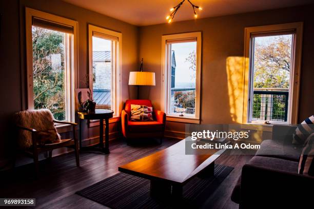 stylish clean neat living room at sunset - clean house stockfoto's en -beelden