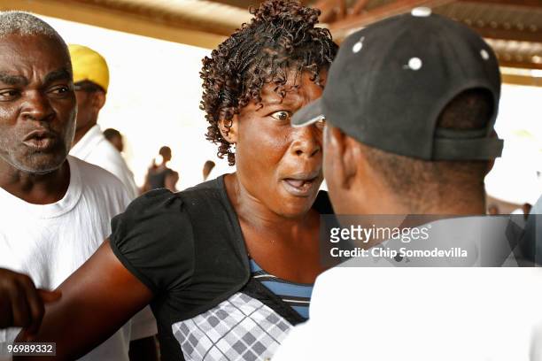 Christian woman screams at a group of Voodooists as a mob attacked a Haitian Voodoo ceremony for earthquake victims in the Ti Ayiti neighborhood...