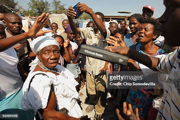 Voodooist is surrounded by a violent Christian mob as she attempts to escape a Haitian Voodoo ceremony for earthquake victims in the Ti Ayiti...