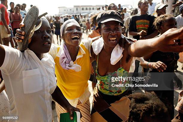 Women cheer after a Christian mob attacked a Voodoo ceremony for earthquake victims in the Ti Ayiti neighborhood February 23, 2010 in Cité Soleil,...