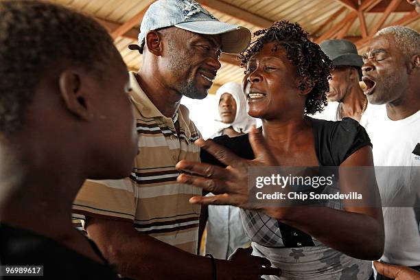 Haitian Voodoo Houngan, or priest, Jul Miste attempts to calm a Christian mob that attacked a Voodoo ceremony for earthquake victims in the Ti Ayiti...