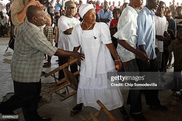Haitian Voodooist is restrained after a Christian mob attacked a Voodoo ceremony for earthquake victims in the Ti Ayiti neighborhood February 23,...