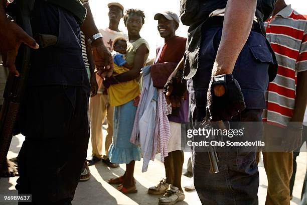 Haitian police attempt to calm a crowd of violent Christians that were threatening to attack a Voodoo ceremony for earthquake victims in the Ti Ayiti...