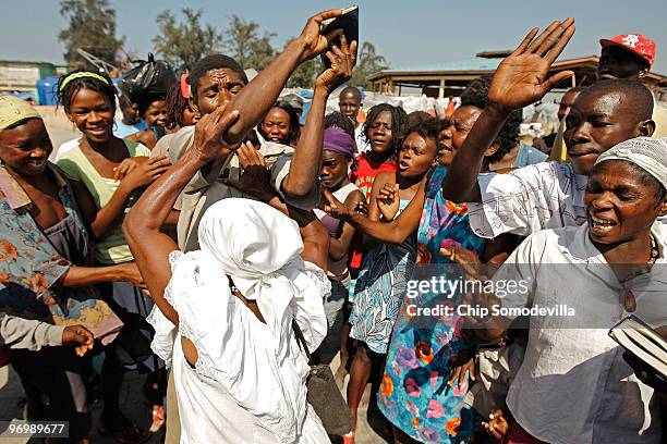 Voodooist is surrounded by a violent Christian mob as she attempts to escape a Haitian Voodoo ceremony for earthquake victims in the Ti Ayiti...