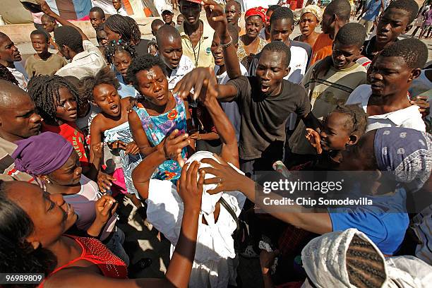 Voodooist is surrounded by a violent Christian mob as she attempts to escape a Haitian Voodoo ceremony for earthquake victims in the Ti Ayiti...