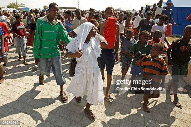 Voodooist is surrounded by a violent Christian mob as she attempts to escape a Haitian Voodoo ceremony for earthquake victims in the Ti Ayiti...