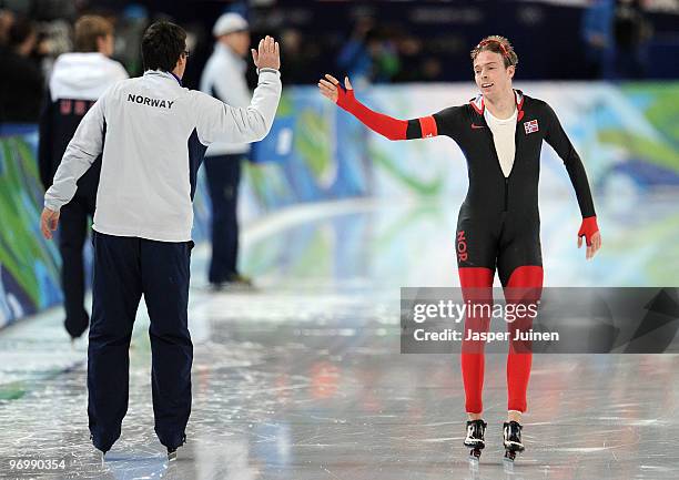 Sverre Haugli of Norway reacys with his coach after his skate in the men's speed skating 10000 m on day 12 of the 2010 Vancouver Winter Olympics at...