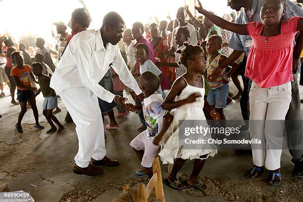 Haitian Voodooist attempts to push back a Christian mob as it attacks a Voodoo ceremony for earthquake victims in the Ti Ayiti neighborhood February...